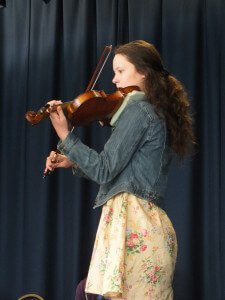 Young Girl Playing Violin at Concert