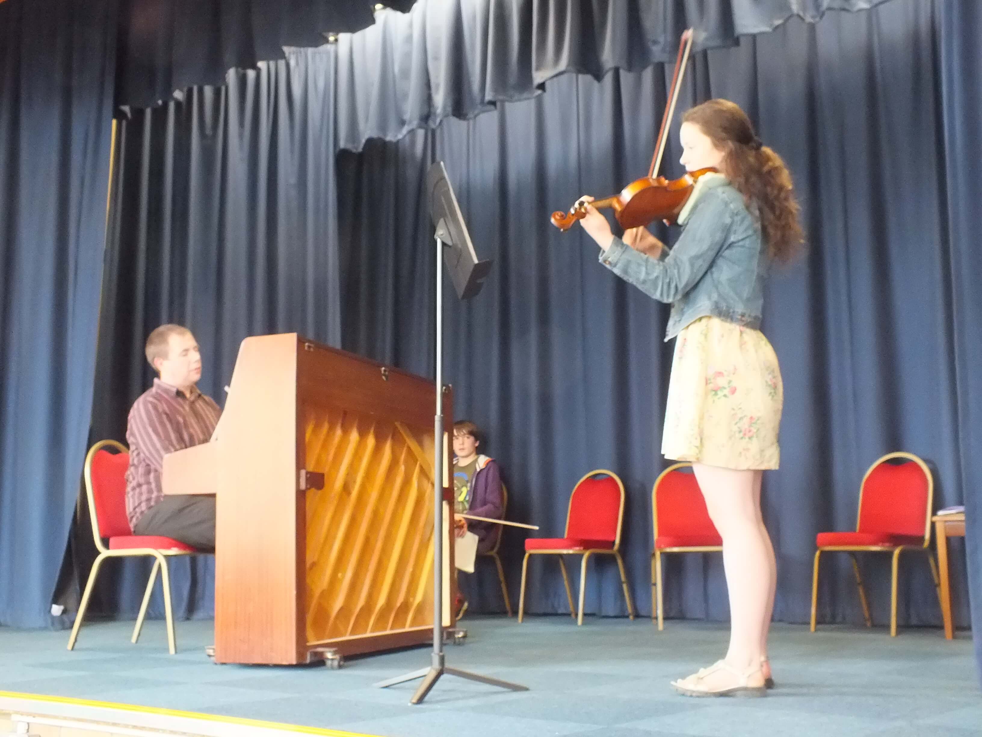 Teenage Violinist Accompanied by Teacher Simon Jordan
